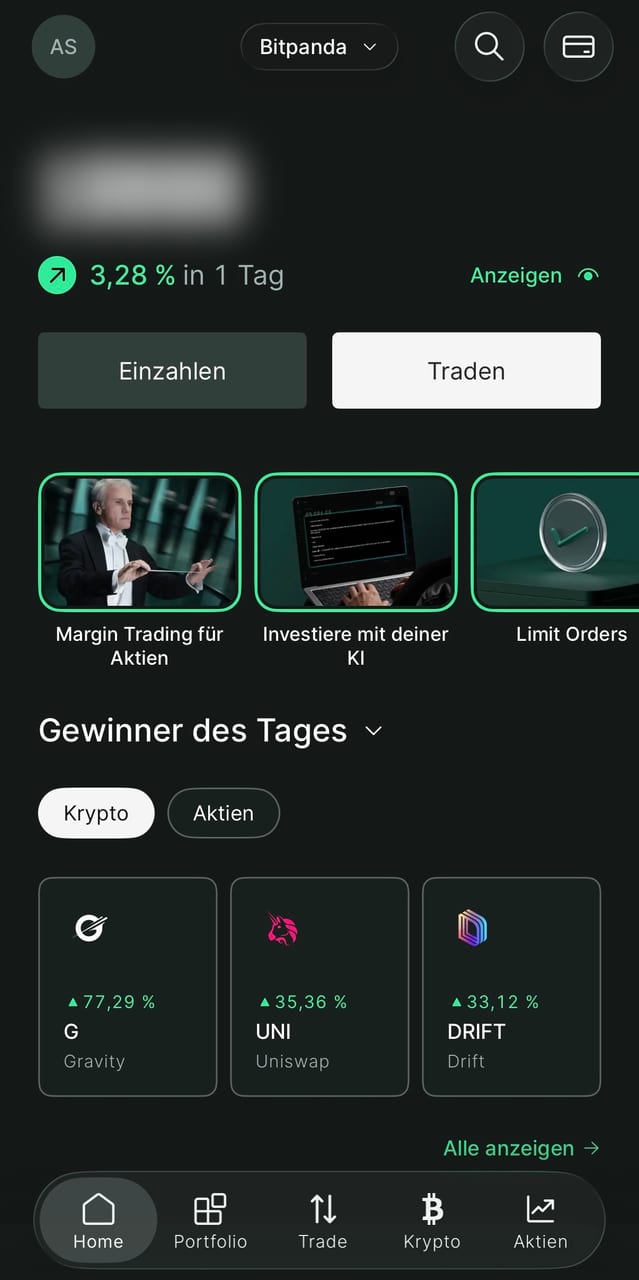 Startansicht der Bitpanda-App mit Einzahlen- und Traden-Knopf sowie den Tagesgewinnern